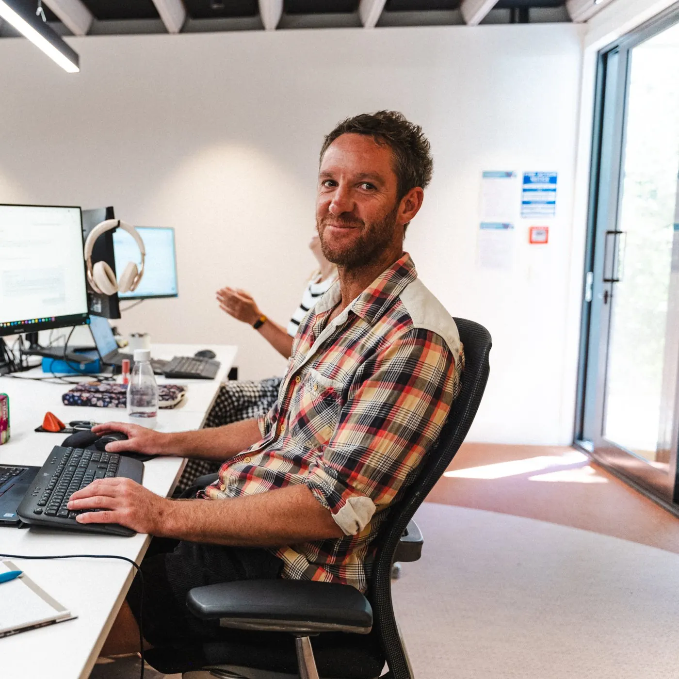 A Roost team member sharing a laugh at his desk